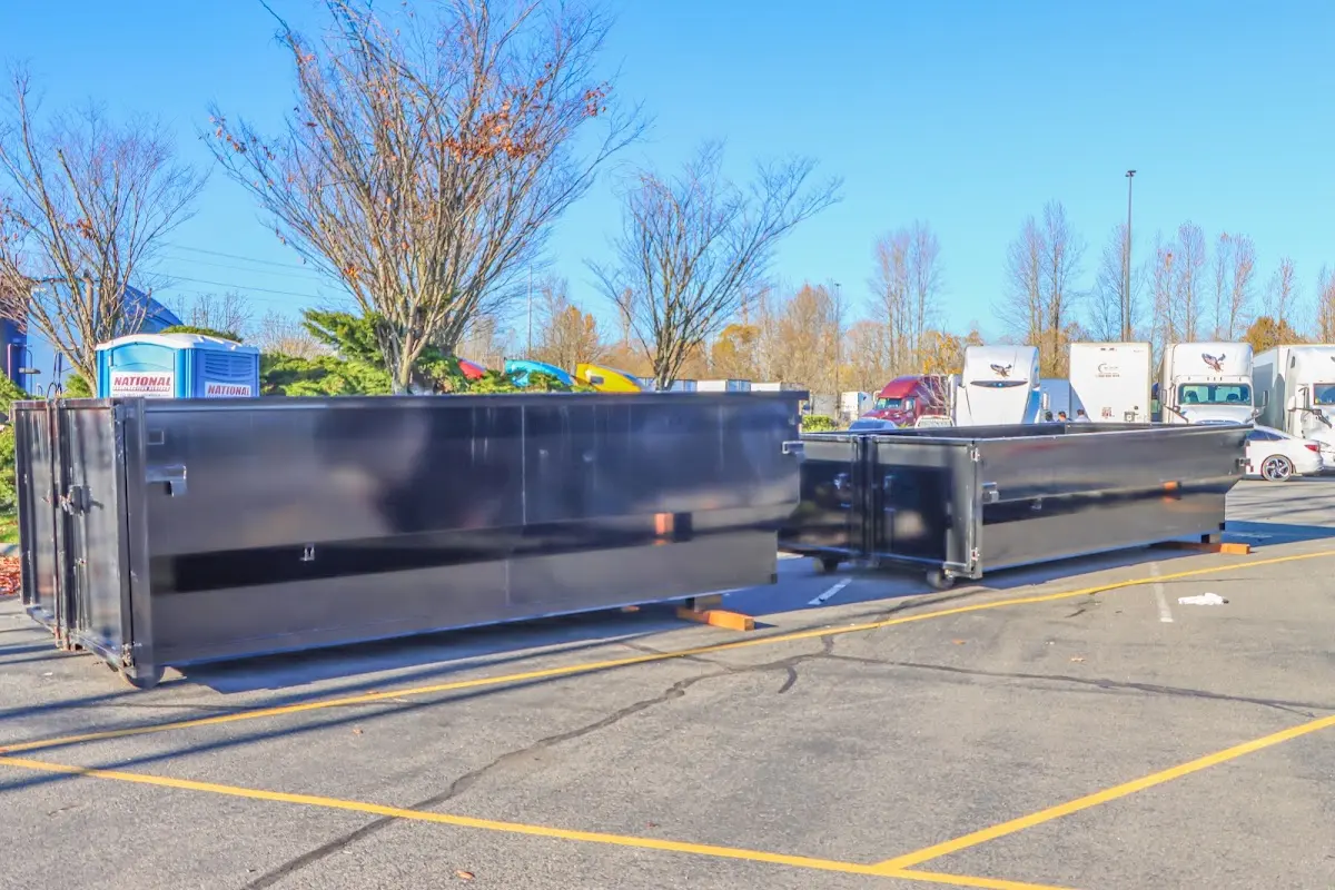 Professional dumpster rental service with roll-off container on residential driveway in Blackfoot